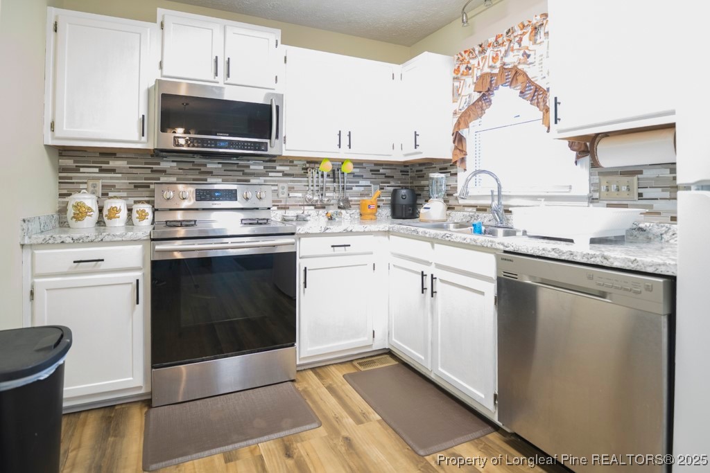 5014 Summer Ridge Road Fayetteville, NC 28303 - Photo 11 of 20 a kitchen with a sink stove and microwave