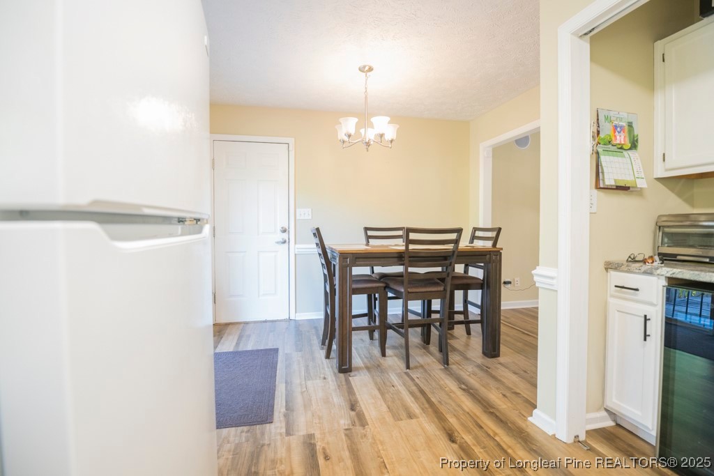 5014 Summer Ridge Road Fayetteville, NC 28303 - Photo 13 of 20 a view of a dining room with furniture and wooden floor