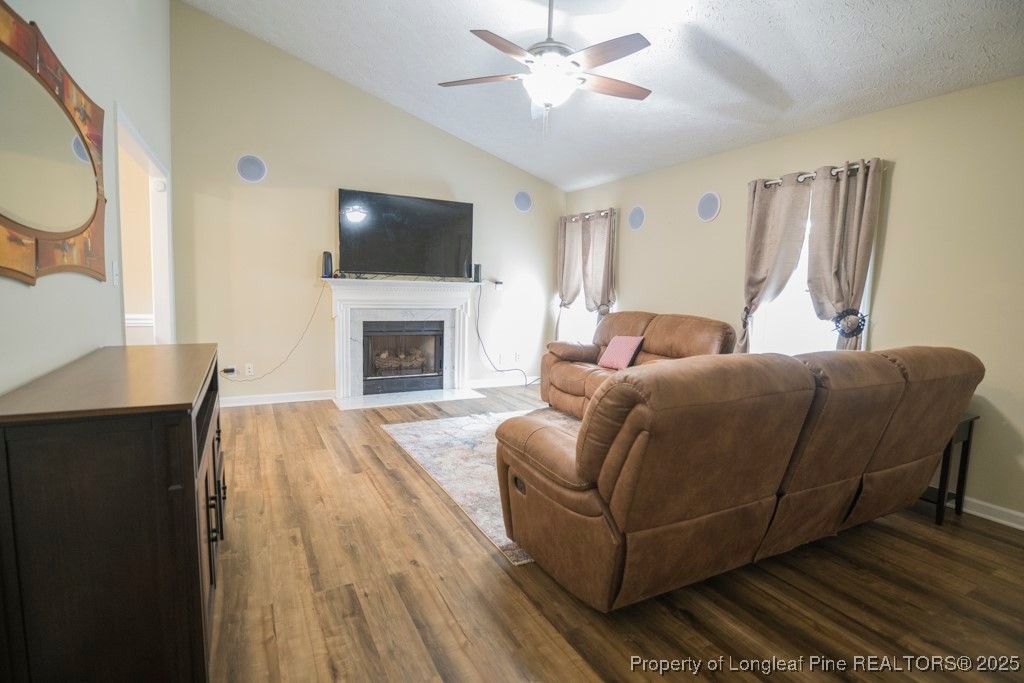 5014 Summer Ridge Road Fayetteville, NC 28303 - Photo 6 of 20 a living room with furniture a flat screen tv and a fireplace