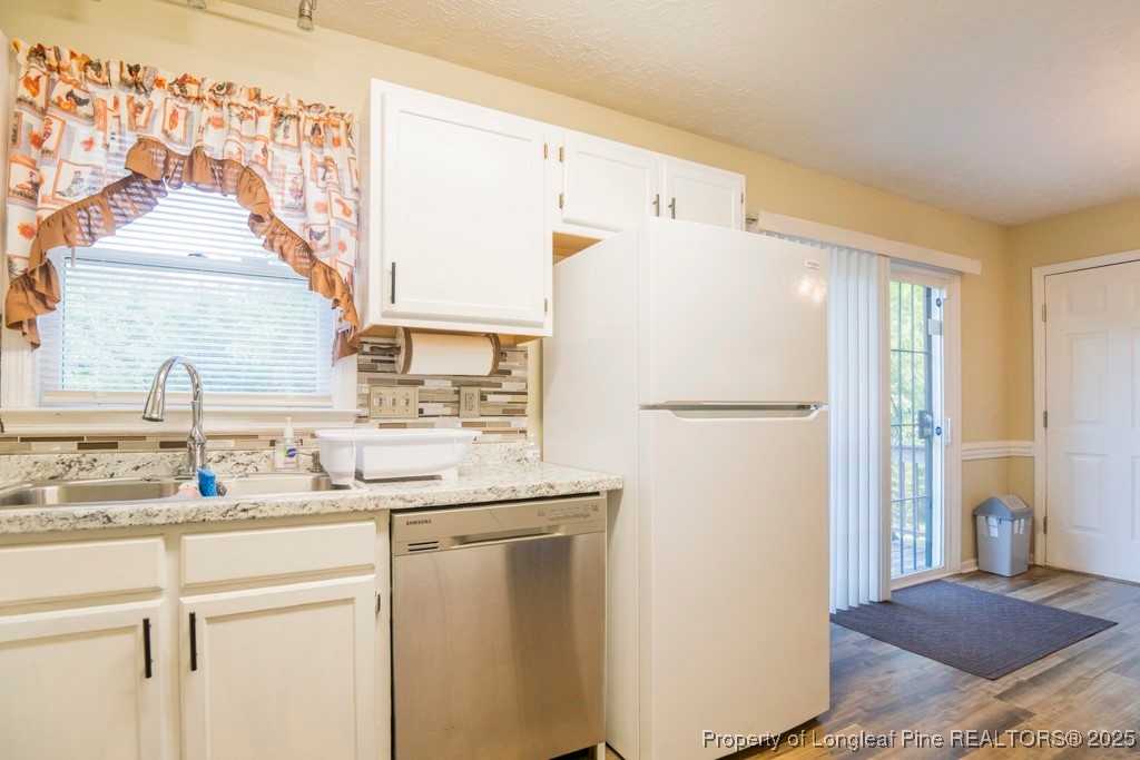 5014 Summer Ridge Road Fayetteville, NC 28303 - Photo 10 of 20 a kitchen with a refrigerator and a sink