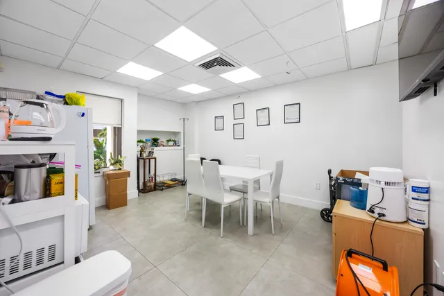 a dining room with furniture and a window