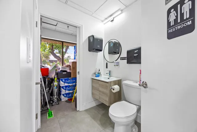 a bathroom with a toilet a sink and a shower