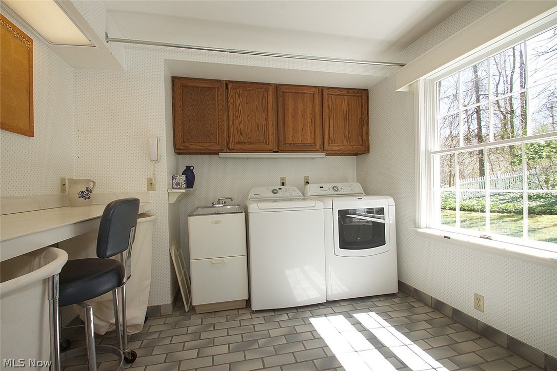 442 Riverview Road Gates Mills, OH 44040 - Photo 15 of 29 First floor large laundry room with hanging space and a folding table - along with lovely views out a large window