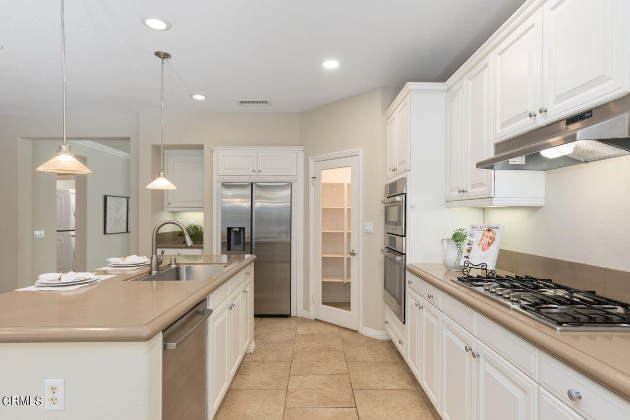 11249 Figtree Terrace Road Corona, CA 92883 - Photo 19 of 53 a kitchen with a sink stove and refrigerator