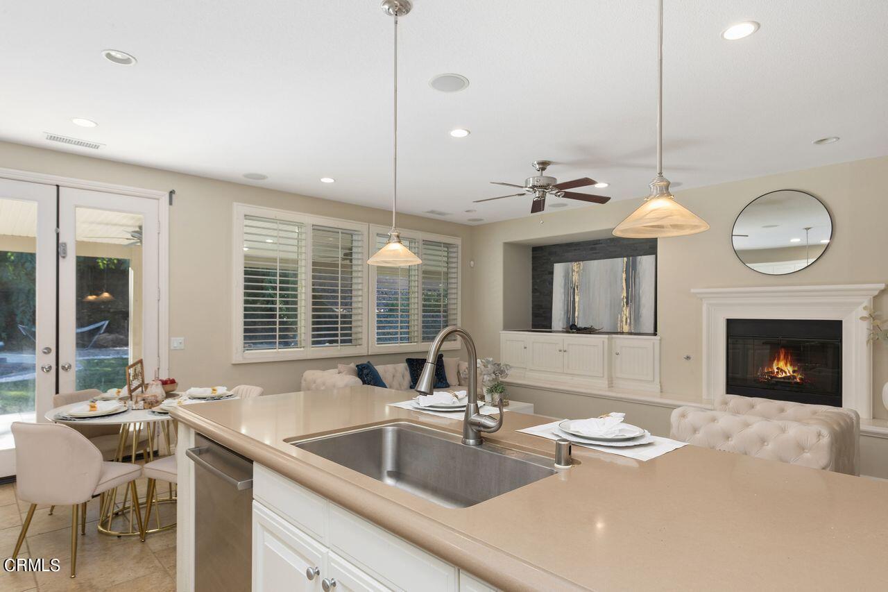 11249 Figtree Terrace Road Corona, CA 92883 - Photo 20 of 53 a kitchen with a sink and a fireplace