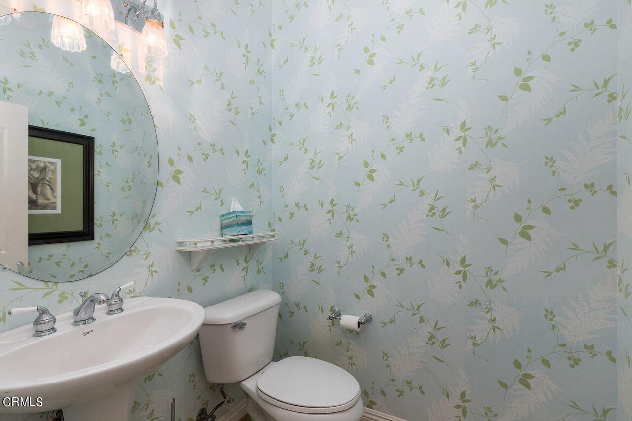 11249 Figtree Terrace Road Corona, CA 92883 - Photo 21 of 53 a bathroom with a sink a toilet and mirror