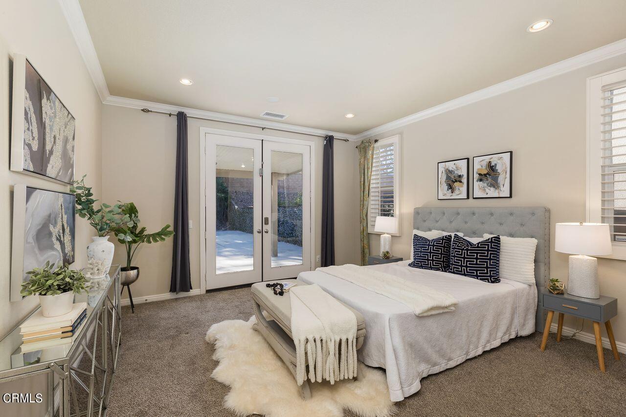 11249 Figtree Terrace Road Corona, CA 92883 - Photo 23 of 53 a bedroom with a large bed and a potted plant