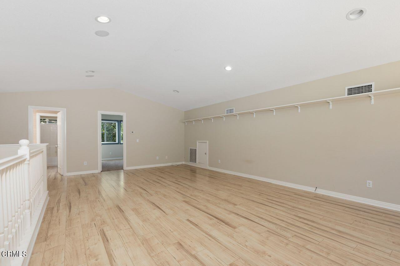 11249 Figtree Terrace Road Corona, CA 92883 - Photo 28 of 53 a view of an empty room with wooden floor and a window