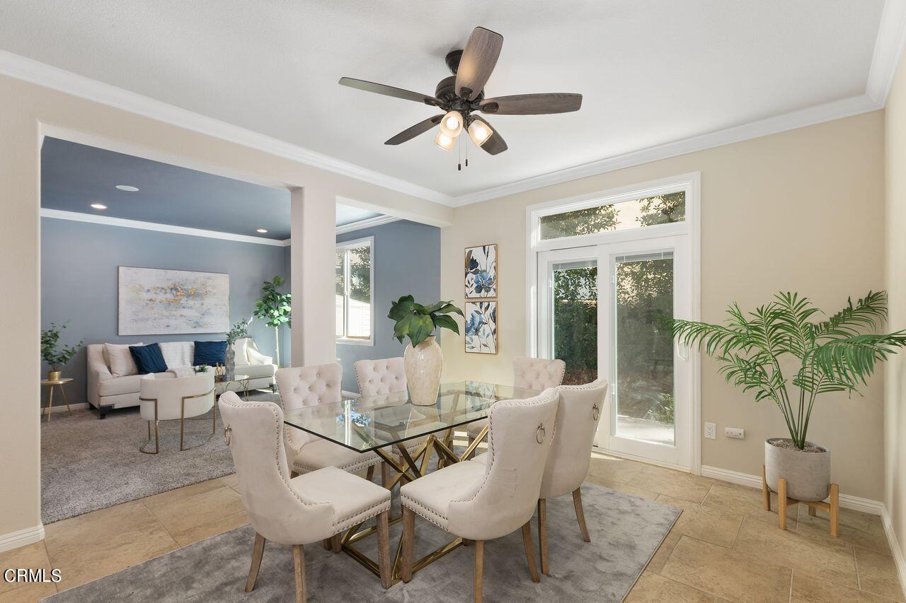 11249 Figtree Terrace Road Corona, CA 92883 - Photo 8 of 53 a dining room with furniture potted plants and a ceiling fan