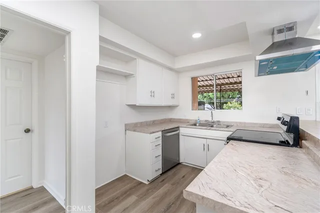 a kitchen with a sink stove and cabinets
