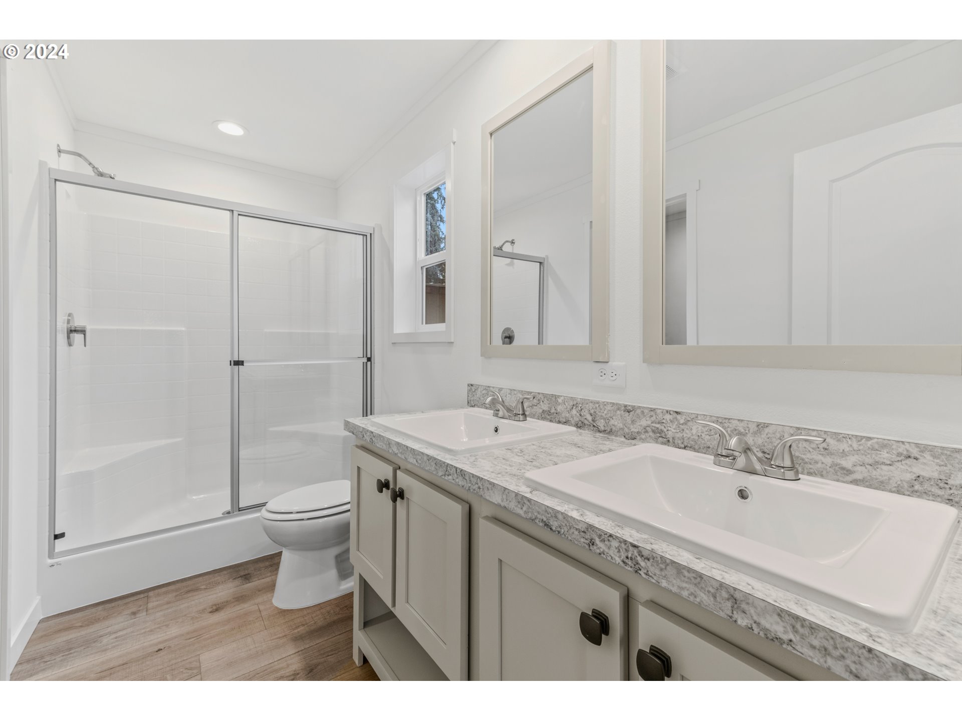 9700 Southwest Tualatin Road, Unit 39 Tualatin, OR 97062 - Photo 15 of 28 a bathroom with a granite countertop sink a toilet a mirror and shower