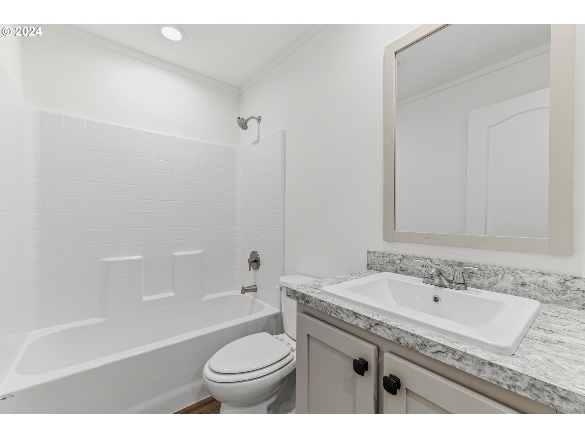 9700 Southwest Tualatin Road, Unit 39 Tualatin, OR 97062 - Photo 19 of 28 a bathroom with a granite countertop sink a toilet and bathtub
