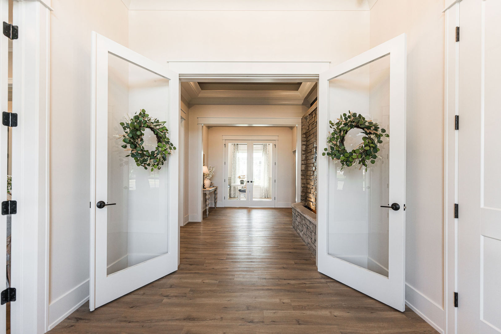 108 Boulder Court, Unit 108 Genoa, IL 60135 - Photo 18 of 25 a view of a hallway with wooden floor and a glass door