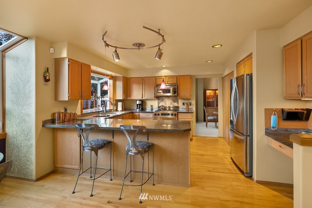932 South 32nd Place Renton, WA 98055 - Photo 11 of 31 a kitchen with stainless steel appliances kitchen island granite countertop a refrigerator and cabinets