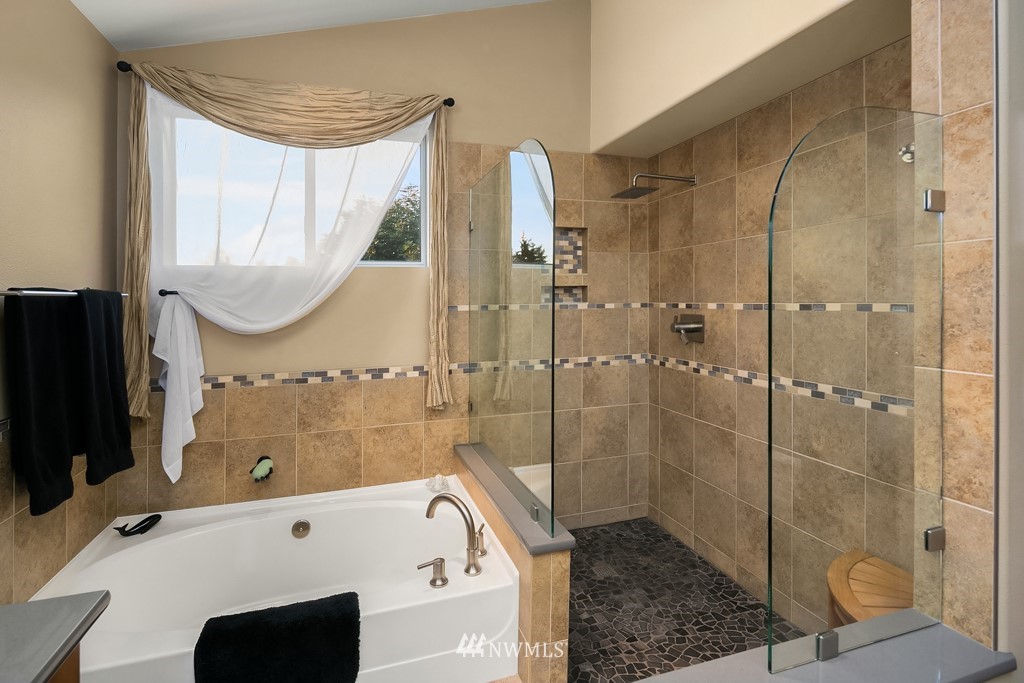 932 South 32nd Place Renton, WA 98055 - Photo 23 of 31 a bathroom with a tub a sink and a shower