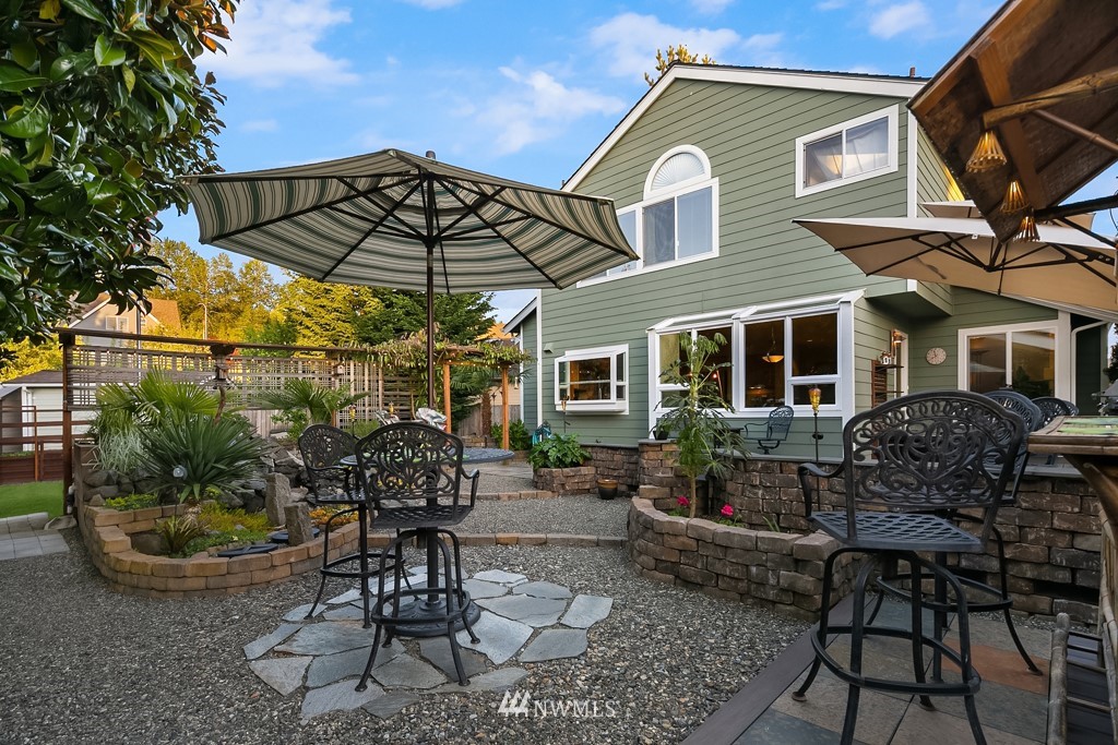 932 South 32nd Place Renton, WA 98055 - Photo 28 of 31 a backyard of a house with table and chairs
