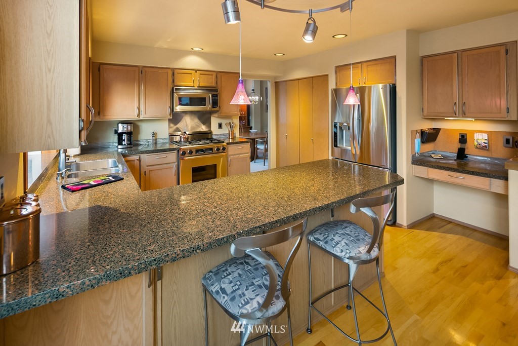 932 South 32nd Place Renton, WA 98055 - Photo 9 of 31 a kitchen with stainless steel appliances granite countertop a sink refrigerator and microwave