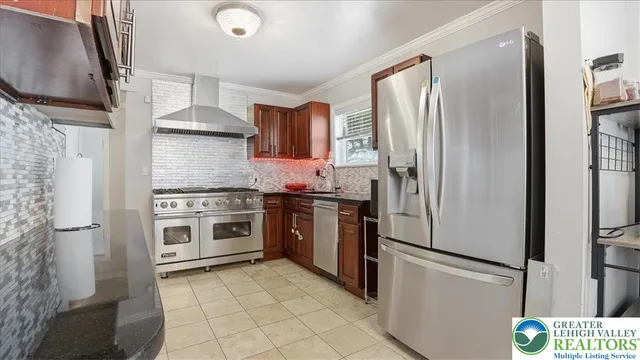 a kitchen with granite countertop cabinets stainless steel appliances and a sink
