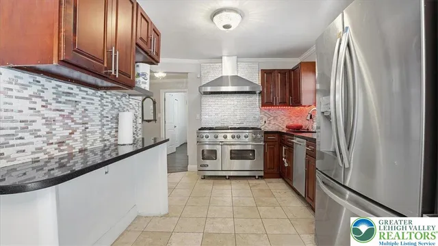 a kitchen with stainless steel appliances granite countertop a stove and a refrigerator