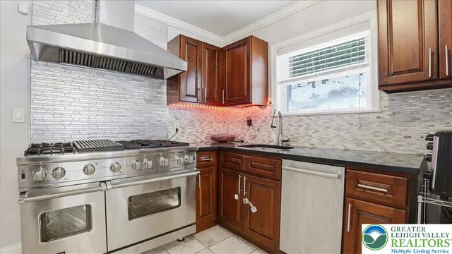 a kitchen with stainless steel appliances a refrigerator sink and stove