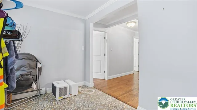 a view of entryway and hall with wooden floor