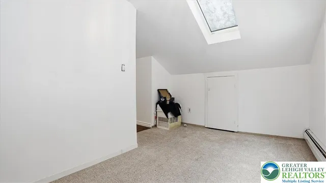 a view of walk in closet with window and glass doors