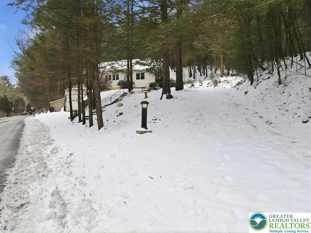 a view of a backyard with a patio and fire pit