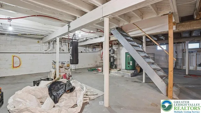 a view of roof deck with couches and wooden fence