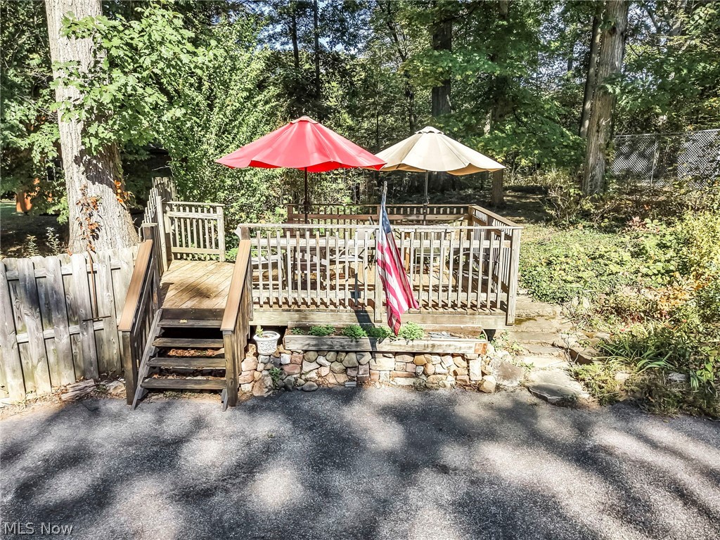 3583 West Bath Road Akron, OH 44333 - Photo 35 of 42 Wood deck with railing, steps, and surrounding mature trees