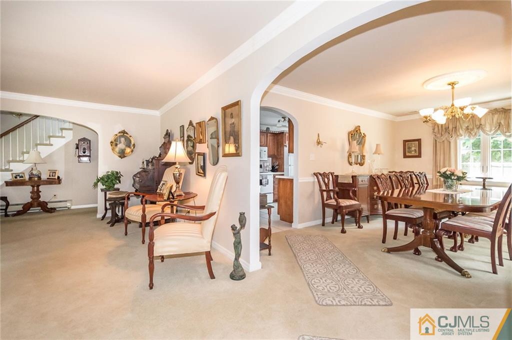 5 Utica Road Edison, NJ 08820 - Photo 15 of 48 a living room with furniture a chandelier and a dining table