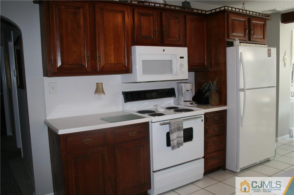 5 Utica Road Edison, NJ 08820 - Photo 18 of 48 a kitchen with stainless steel appliances a refrigerator stove and cabinets