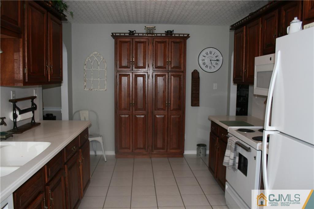 5 Utica Road Edison, NJ 08820 - Photo 19 of 48 a kitchen with a refrigerator and a sink