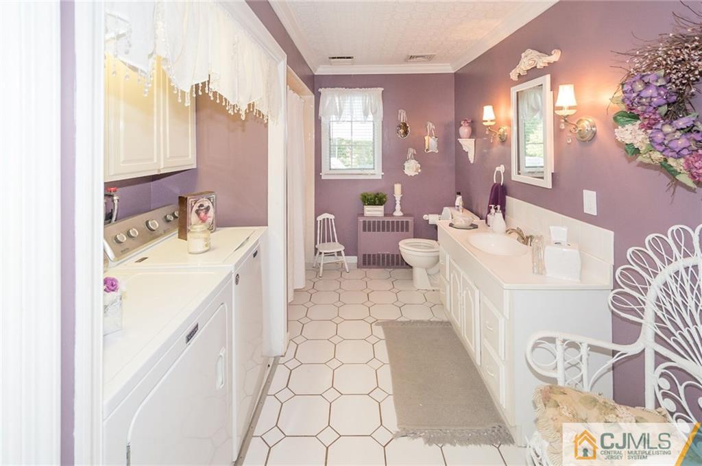 5 Utica Road Edison, NJ 08820 - Photo 21 of 48 a bathroom with a sink a mirror and a bathtub