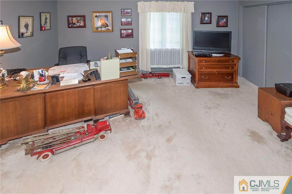 5 Utica Road Edison, NJ 08820 - Photo 24 of 48 a room with furniture and a flat screen tv