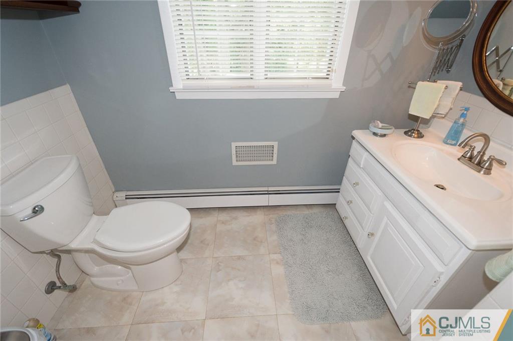 5 Utica Road Edison, NJ 08820 - Photo 33 of 48 a bathroom with a sink toilet and window