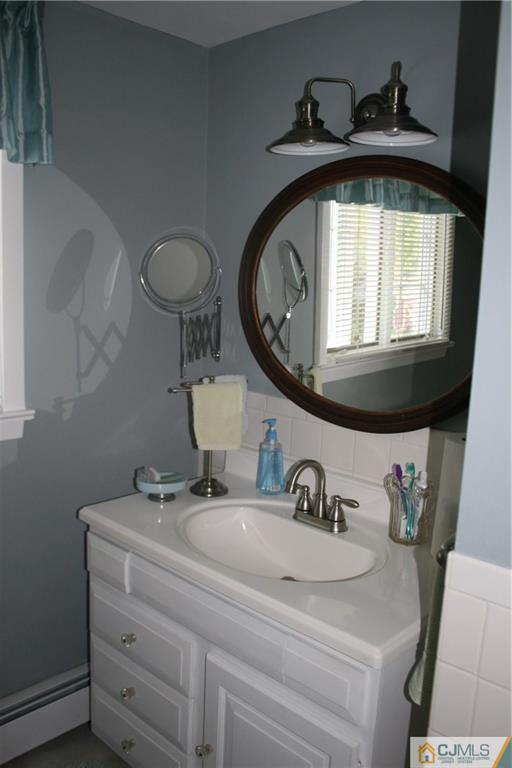 5 Utica Road Edison, NJ 08820 - Photo 34 of 48 a bathroom with a sink and a mirror