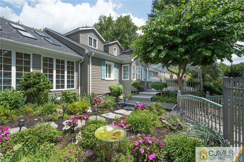 5 Utica Road Edison, NJ 08820 - Photo 37 of 48 a view of a house with a flower garden