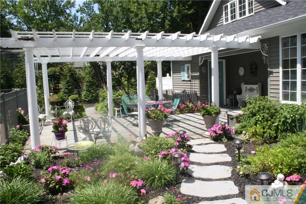 5 Utica Road Edison, NJ 08820 - Photo 40 of 48 a view of a house with sitting area and garden