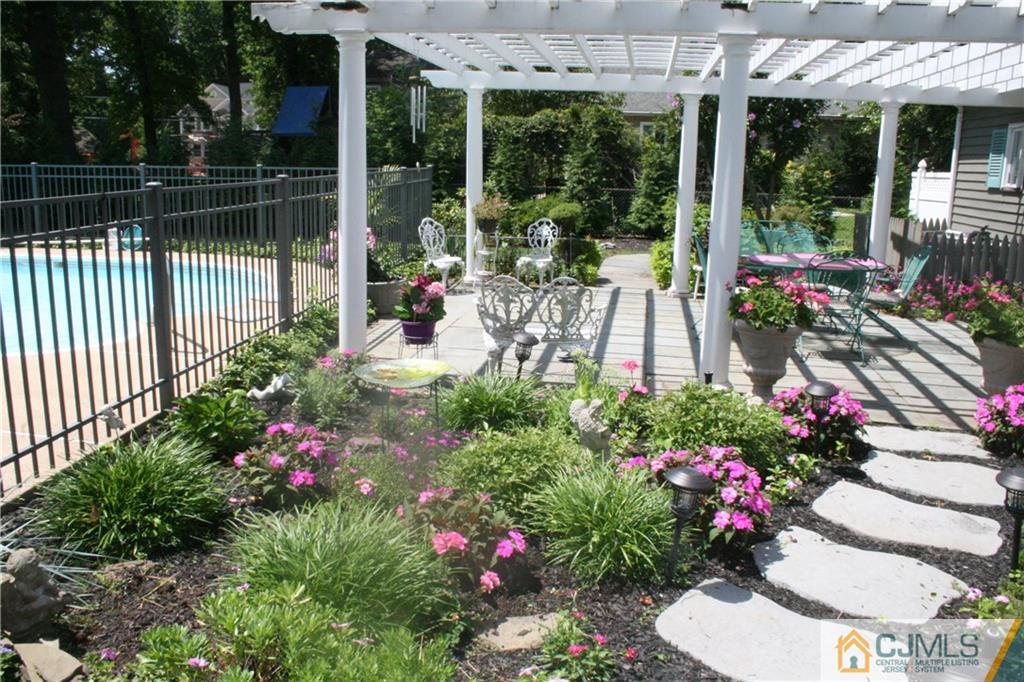 5 Utica Road Edison, NJ 08820 - Photo 41 of 48 a front view of a multi story building with a lot of flower garden