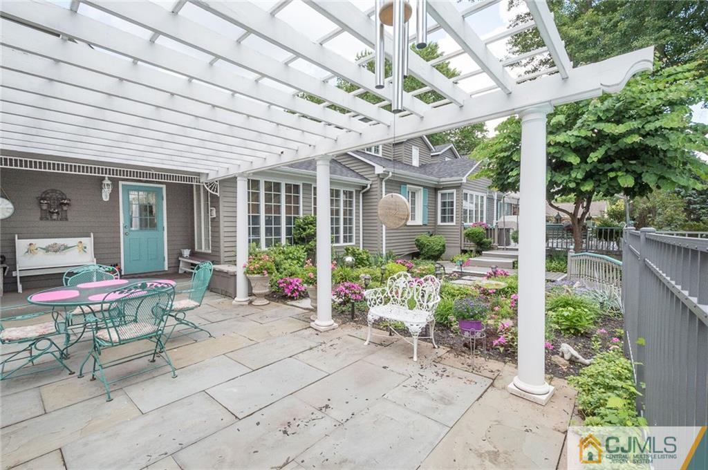 5 Utica Road Edison, NJ 08820 - Photo 42 of 48 a view of a chairs with table in the patio next to a yard