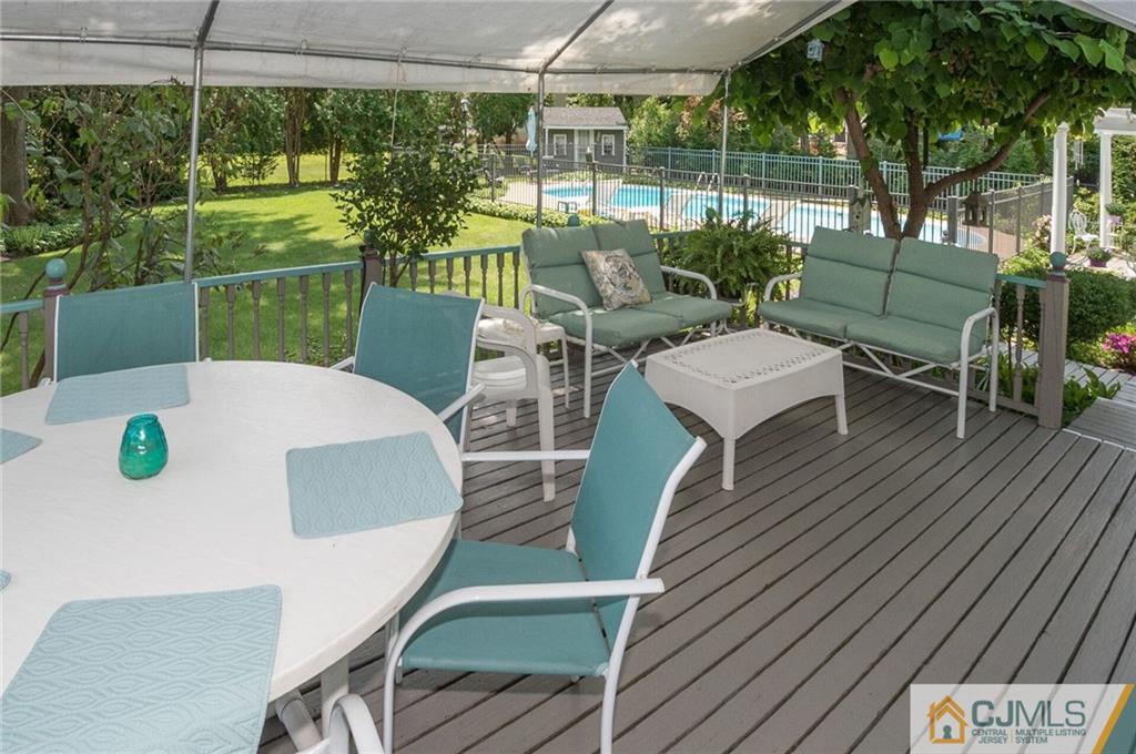 5 Utica Road Edison, NJ 08820 - Photo 43 of 48 a view of a patio with table and chairs potted plants with palm trees