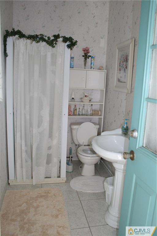 5 Utica Road Edison, NJ 08820 - Photo 46 of 48 a white toilet sitting next to a bathroom sink