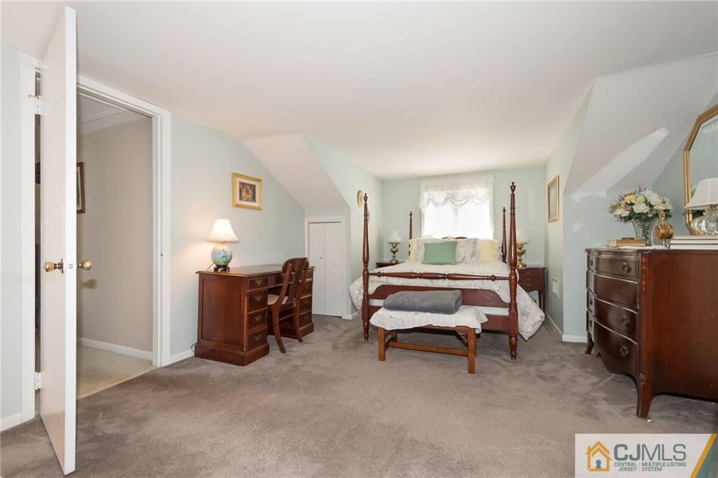 5 Utica Road Edison, NJ 08820 - Photo 7 of 48 a bedroom with furniture and a lamp