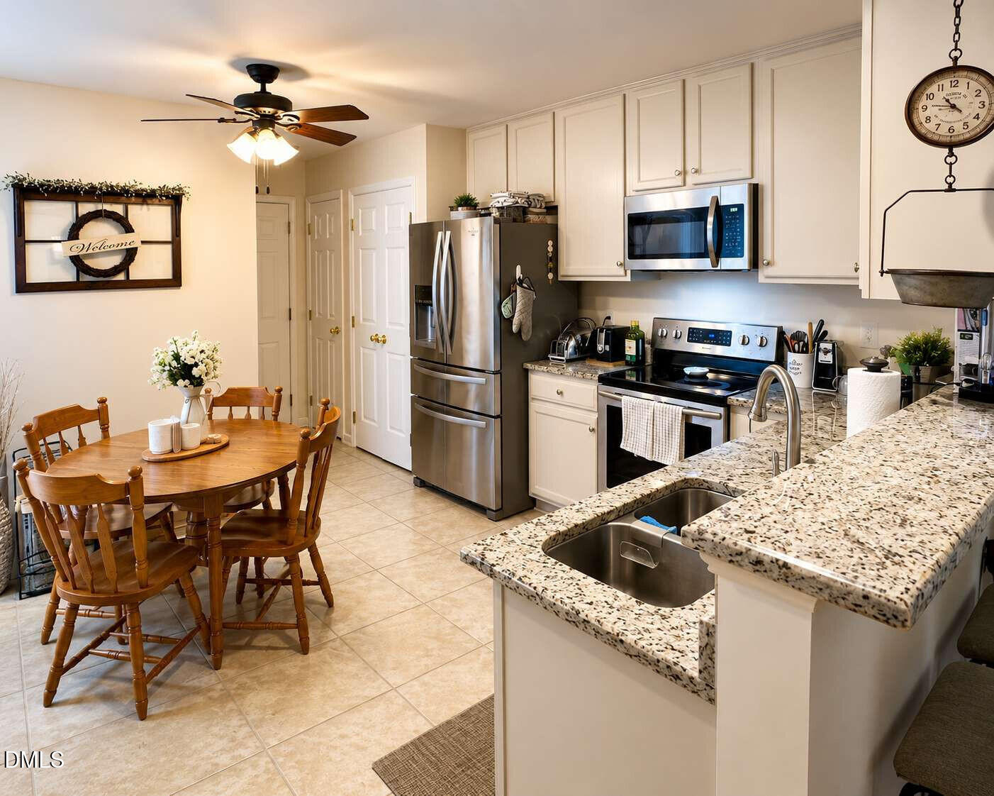 120 Student Place Durham, NC 27713 - Photo 4 of 15 a kitchen with stainless steel appliances kitchen island granite countertop a table chairs and a refrigerator