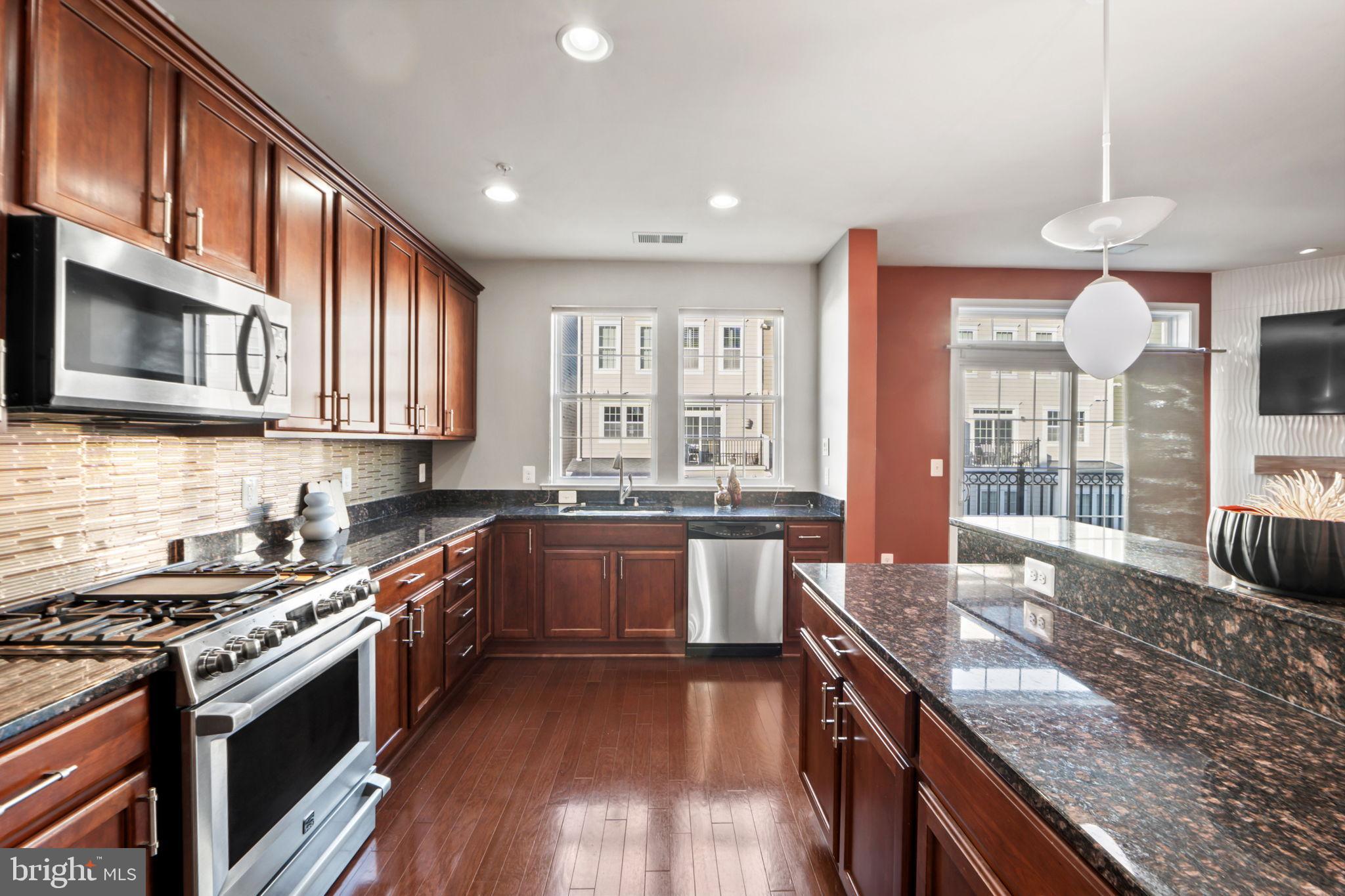 7676 Maple Lawn Boulevard, Unit 2 Fulton, MD 20759 - Photo 19 of 38 Modern kitchen with rich wood cabinetry.