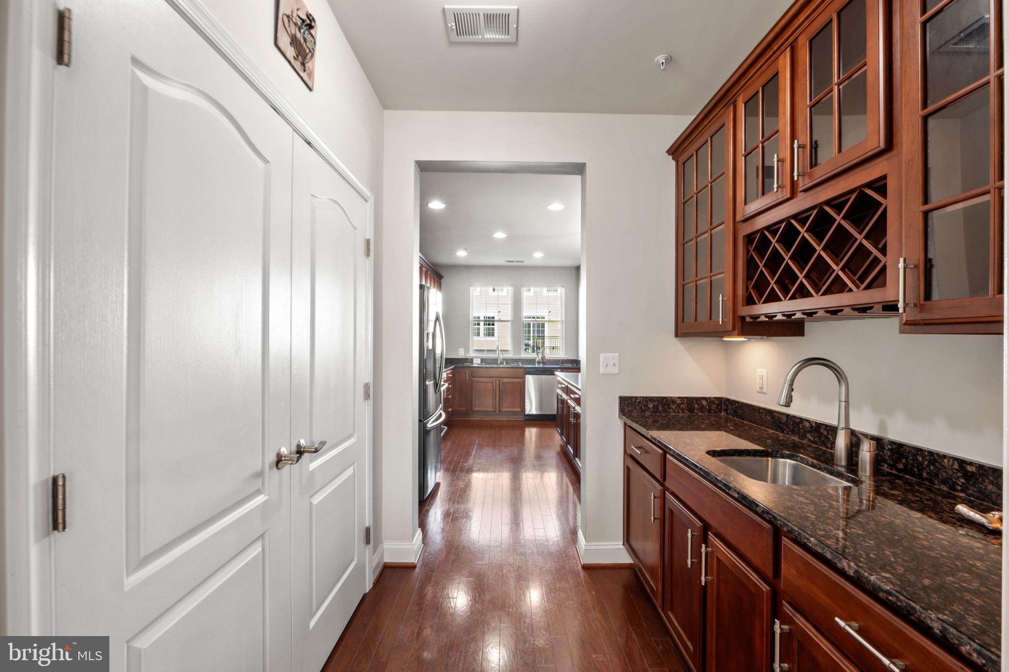 7676 Maple Lawn Boulevard, Unit 2 Fulton, MD 20759 - Photo 21 of 38 Elegant kitchen corridor with rich cabinetry.