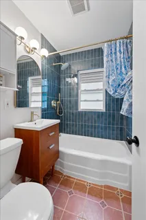 a bathroom with a sink a toilet a bathtub and shower