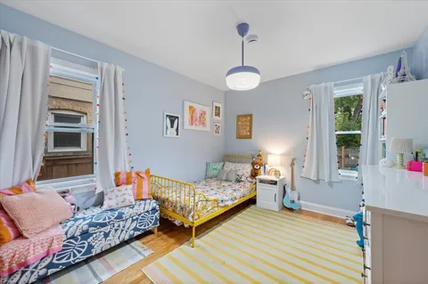 a bedroom with furniture and a wooden floor