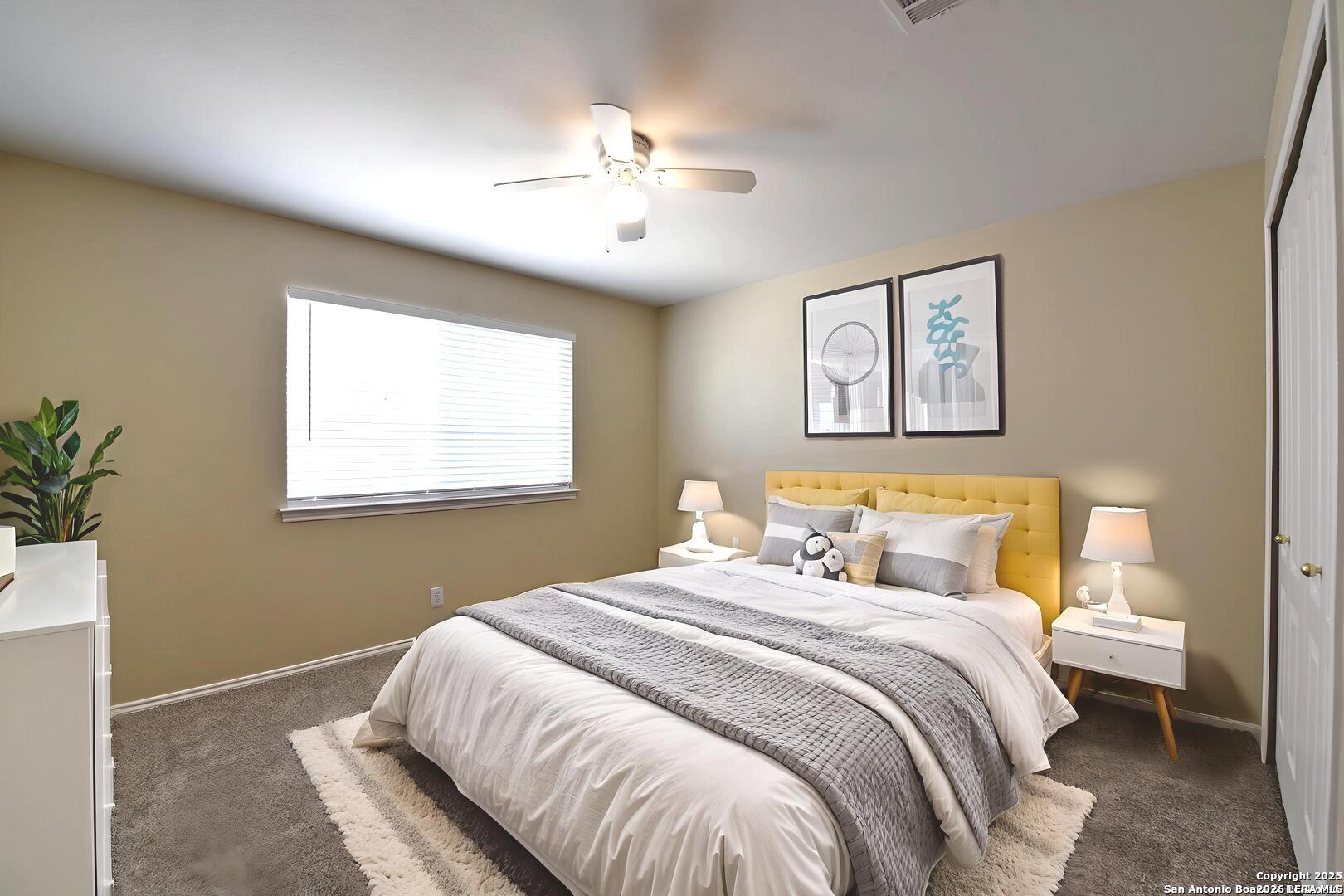 25303 Mesa Ranch San Antonio, TX 78258 - Photo 11 of 54 a bedroom with a large bed and a chandelier