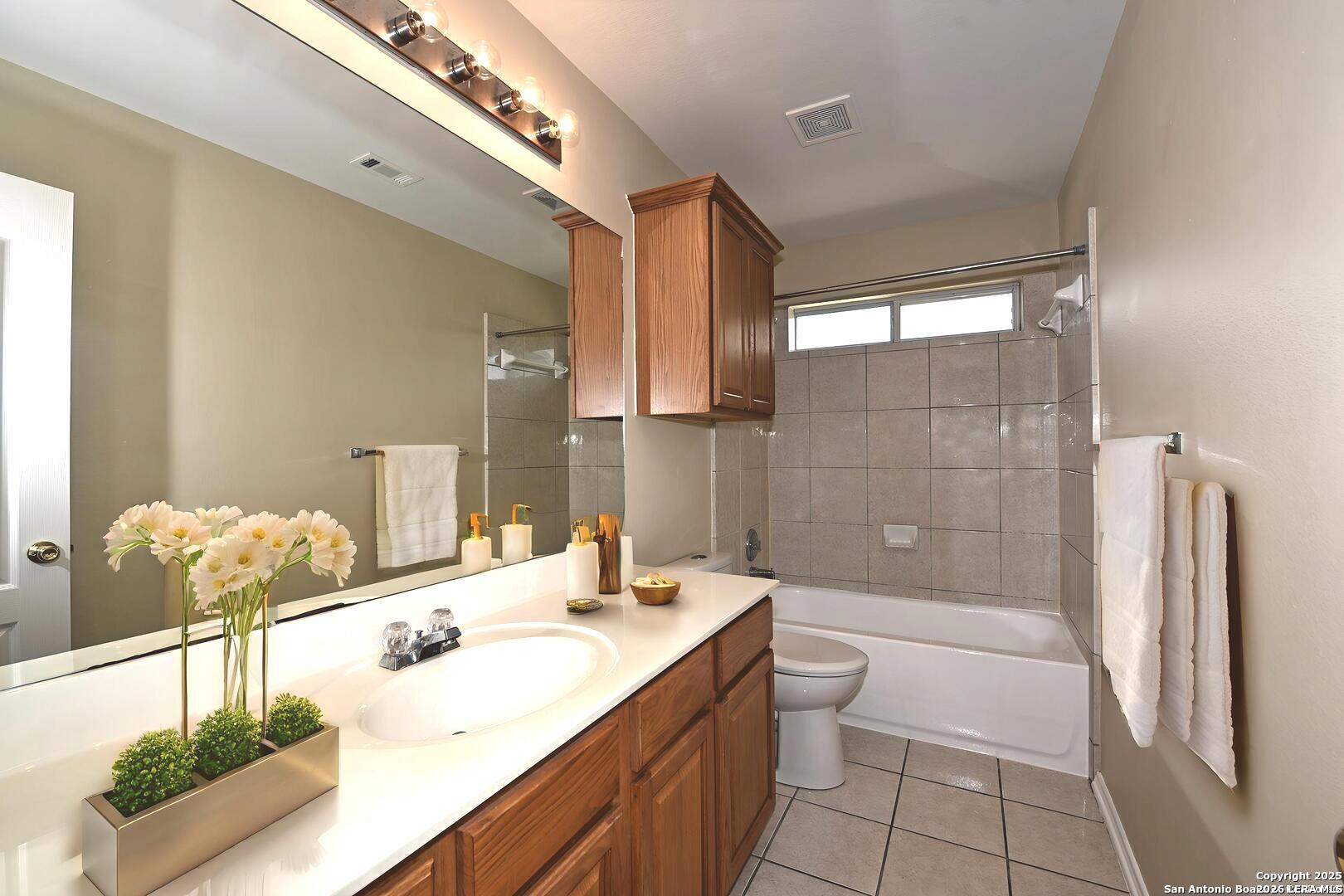 25303 Mesa Ranch San Antonio, TX 78258 - Photo 15 of 54 a bathroom with a double vanity sink toilet and shower